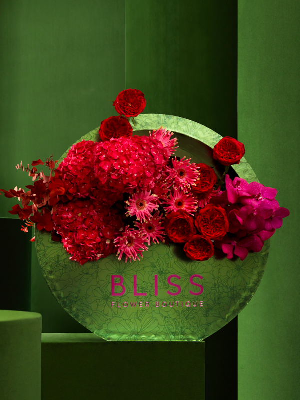 Send red roses in a Bliss bubble bag arrangement