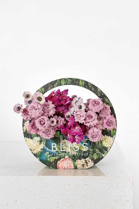 Mix of purple flowers with vanda and anemone on a Bliss bubble bag